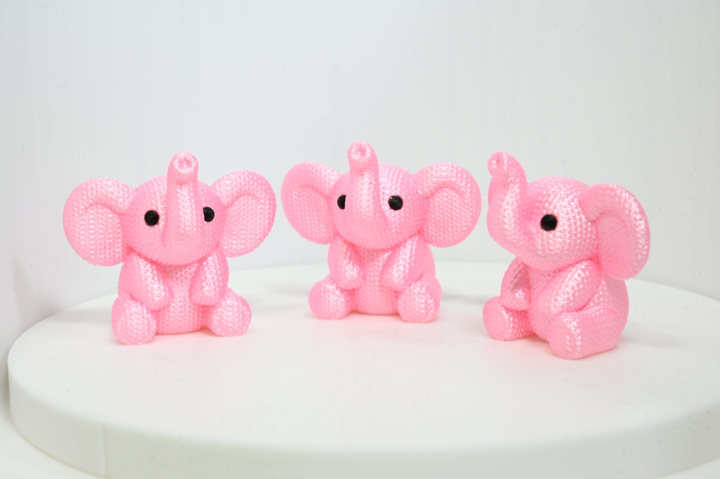 Super cute knitted style elephant with trunk in the air