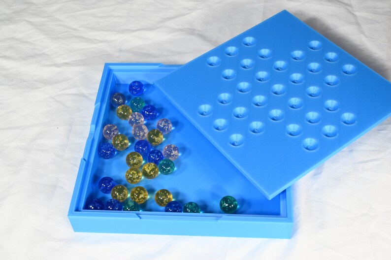 Solitaire game, marble game for one person. Board game for one complete in its own storage box