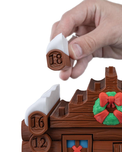 Santa's cabin advent calendar. Count down the days by building Santa's house. North Pole cabin