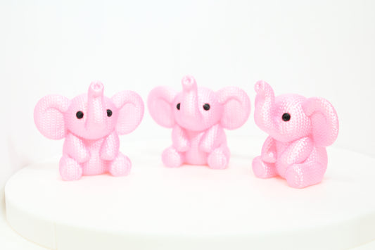 Super cute knitted style elephant with trunk in the air