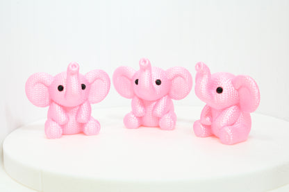Super cute knitted style elephant with trunk in the air
