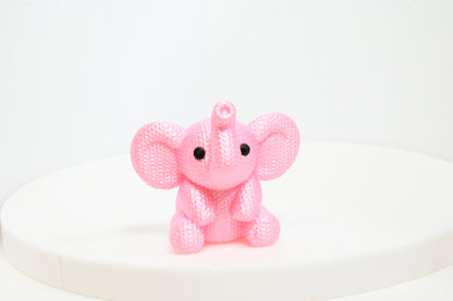 Super cute knitted style elephant with trunk in the air