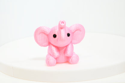 Super cute knitted style elephant with trunk in the air