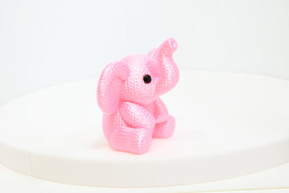 Super cute knitted style elephant with trunk in the air
