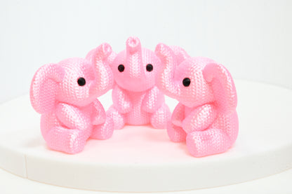 Super cute knitted style elephant with trunk in the air
