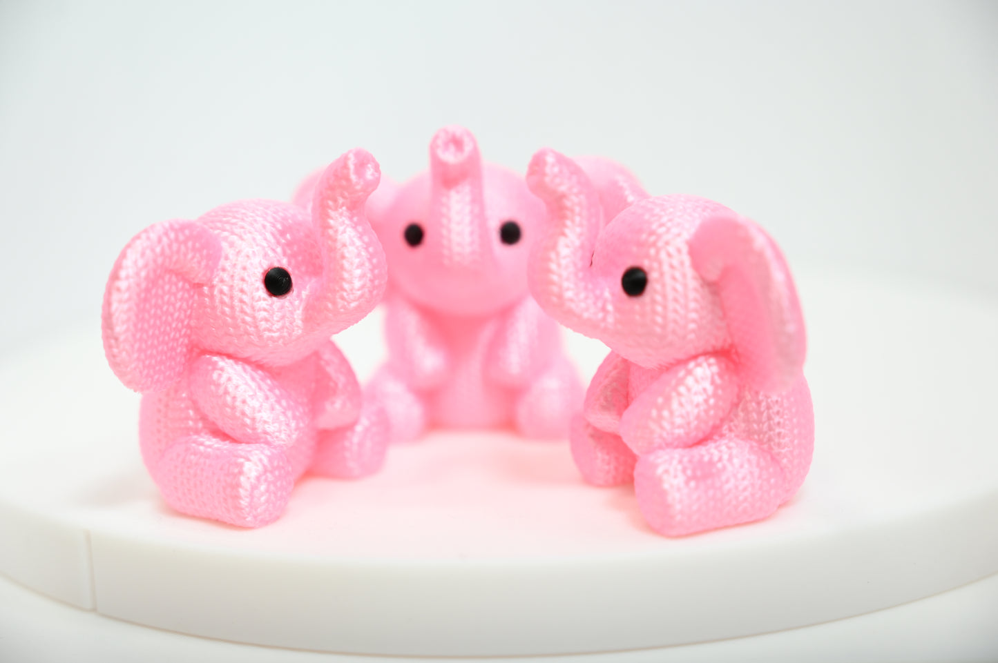 Super cute knitted style elephant with trunk in the air
