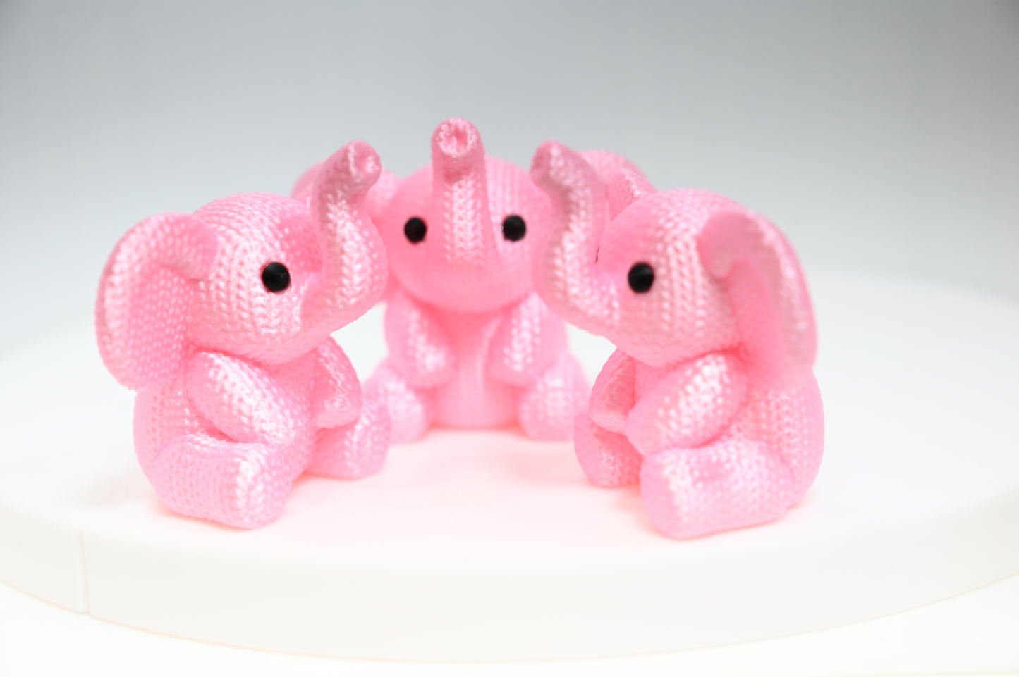 Super cute knitted style elephant with trunk in the air