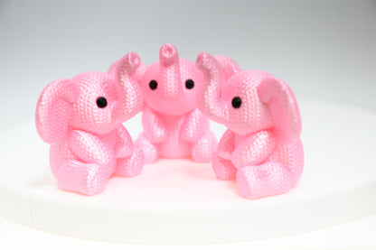 Super cute knitted style elephant with trunk in the air