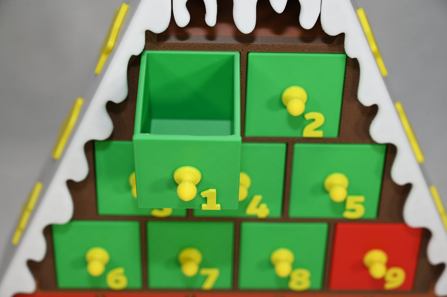 House shaped Christmas advent calendar with individually numbered drawers to countdown to Christmas day