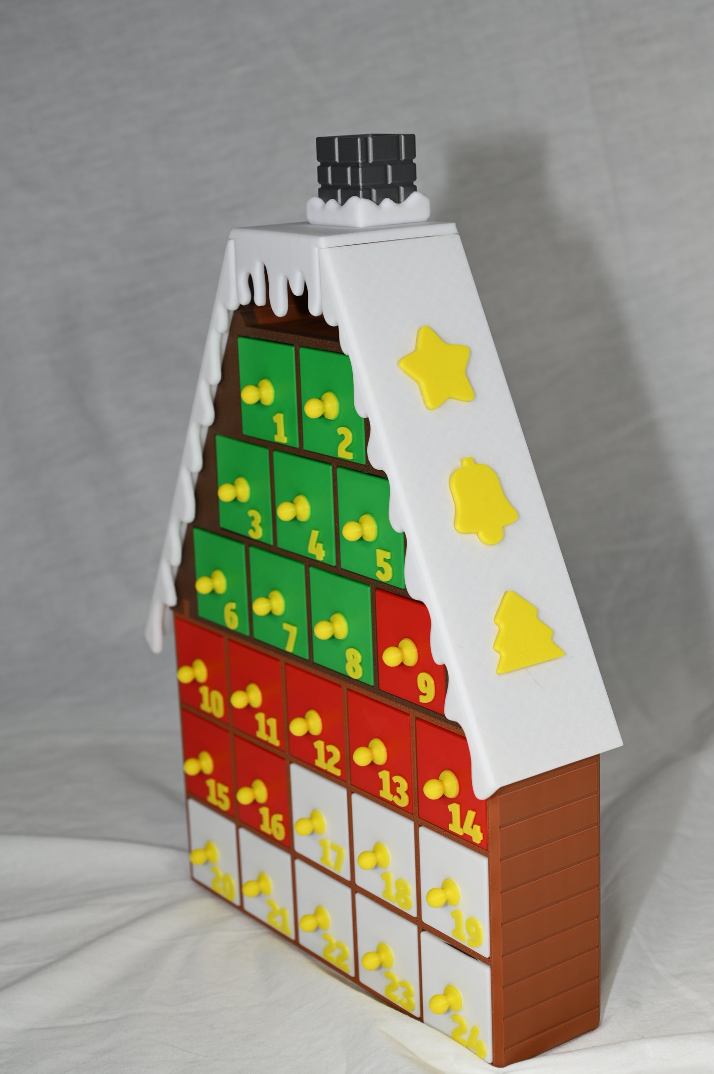House shaped Christmas advent calendar with individually numbered drawers to countdown to Christmas day