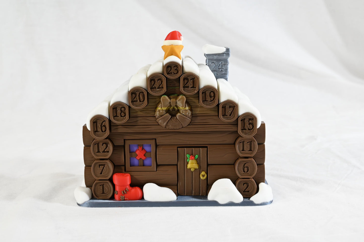 Santa's cabin advent calendar. Count down the days by building Santa's house. North Pole cabin